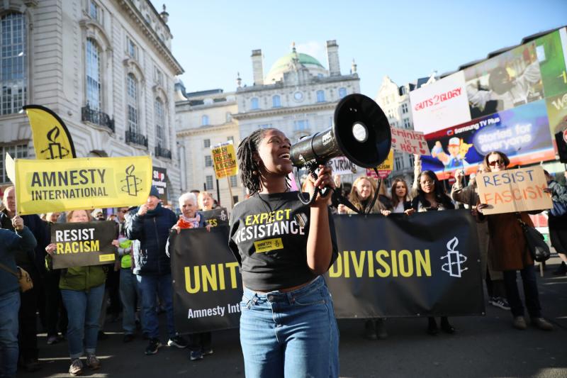 Amnesty International UK members and supporters march in London on 28 March 2026 as part of the Together Alliance to collectively resist hate, division and authoritarianism. 